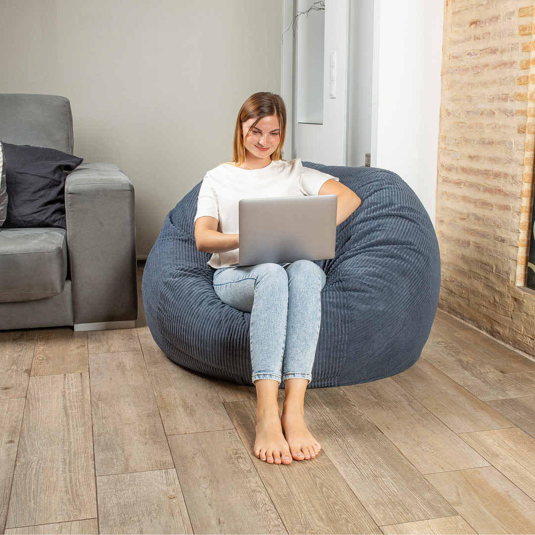 Personne assise sur le pouf-lit convertible 2en1, forme ronde confortable